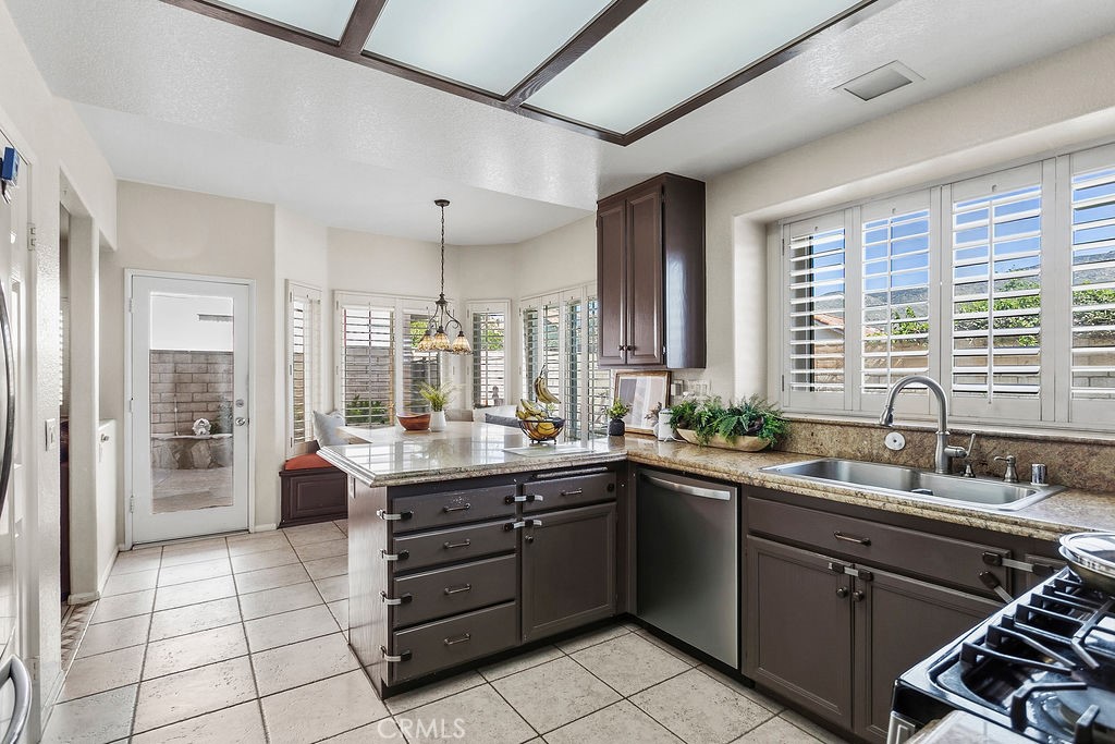 22720 Springmist Drive Moreno Valley, CA 92557 - Photo 7 of 40 a kitchen with a sink and stove