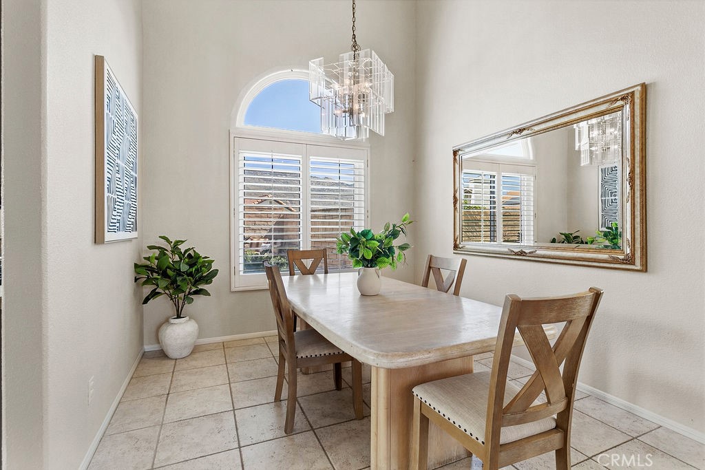 22720 Springmist Drive Moreno Valley, CA 92557 - Photo 9 of 40 a dining room with furniture potted plants and wooden floor