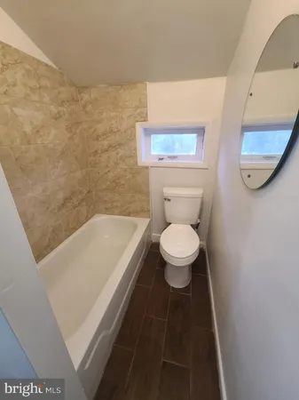 a bathroom with a toilet and a bathtub