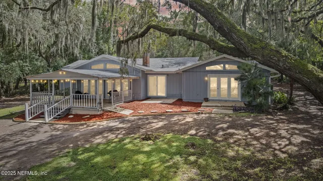 a backyard of a house with barbeque oven table and chairs