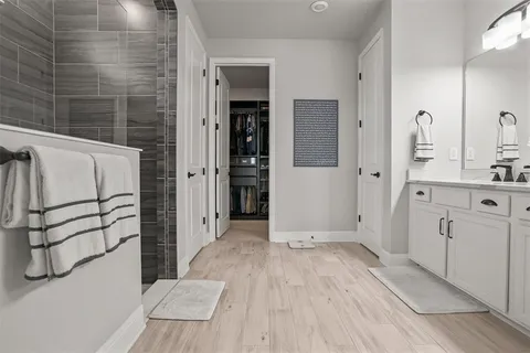 a view of bathroom with a sink and mirror