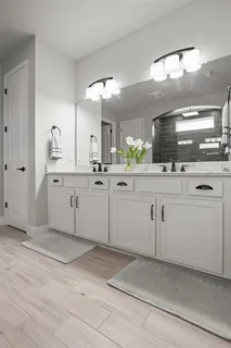 a kitchen with white cabinets appliances and sink