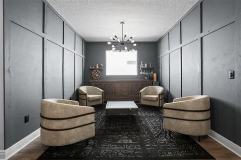 a living room with furniture and a chandelier