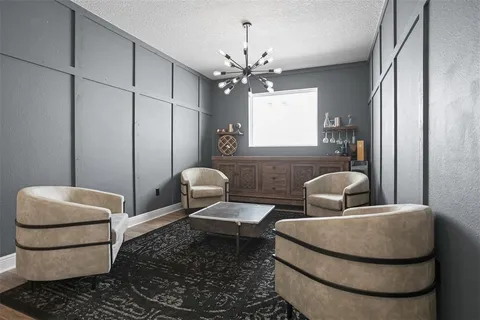 a living room with furniture and a chandelier