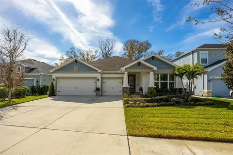 a front view of a house with a yard garage and outdoor seating