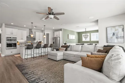 a living room with furniture and kitchen view
