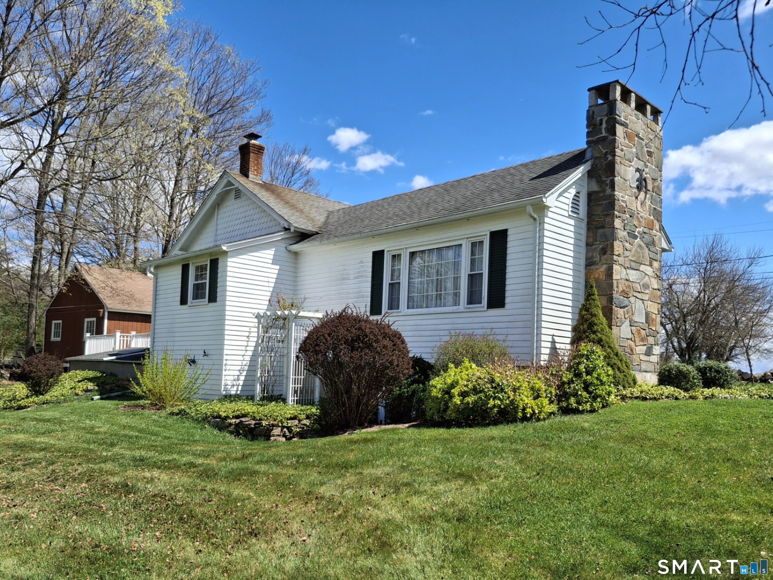 293 Kick Hill Road Lebanon, CT 06249 - Photo 2 of 21 Beautiful stonework on the chimney and picture window overlooking the beautiful backyard with a gorgeous view.