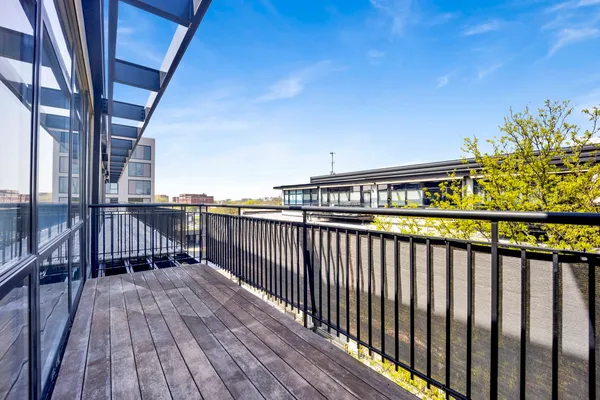 a view of balcony with wooden floor