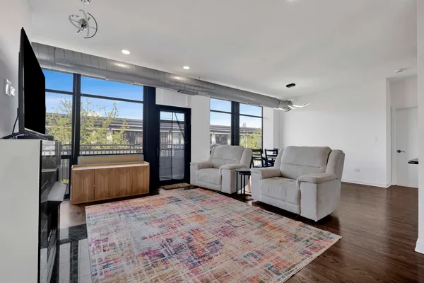 a bedroom with furniture and large windows