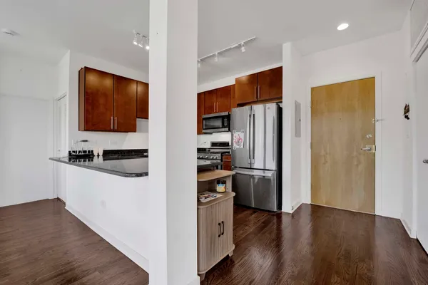 a kitchen with stainless steel appliances a refrigerator and a stove top oven