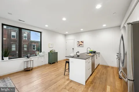 a kitchen with a sink and refrigerator