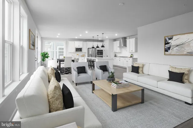 a living room with fireplace furniture and a large window