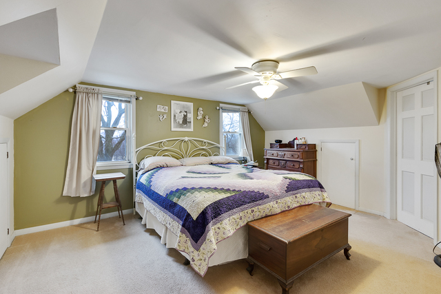 49W435 Plank Road Sycamore, IL 60178 - Photo 14 of 31 a spacious bedroom with a bed and a chandelier