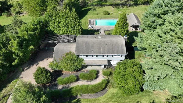 an aerial view of a house with garden space and street view