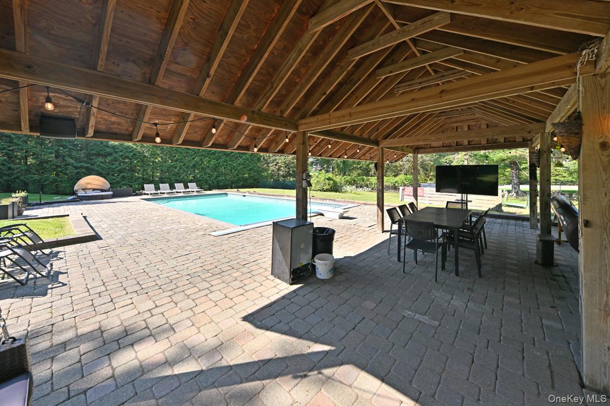 11 Deerwood Road Spring Valley, NY 10977 - Photo 11 of 34 a view of a patio with table and chairs potted plants with wooden floor and fence