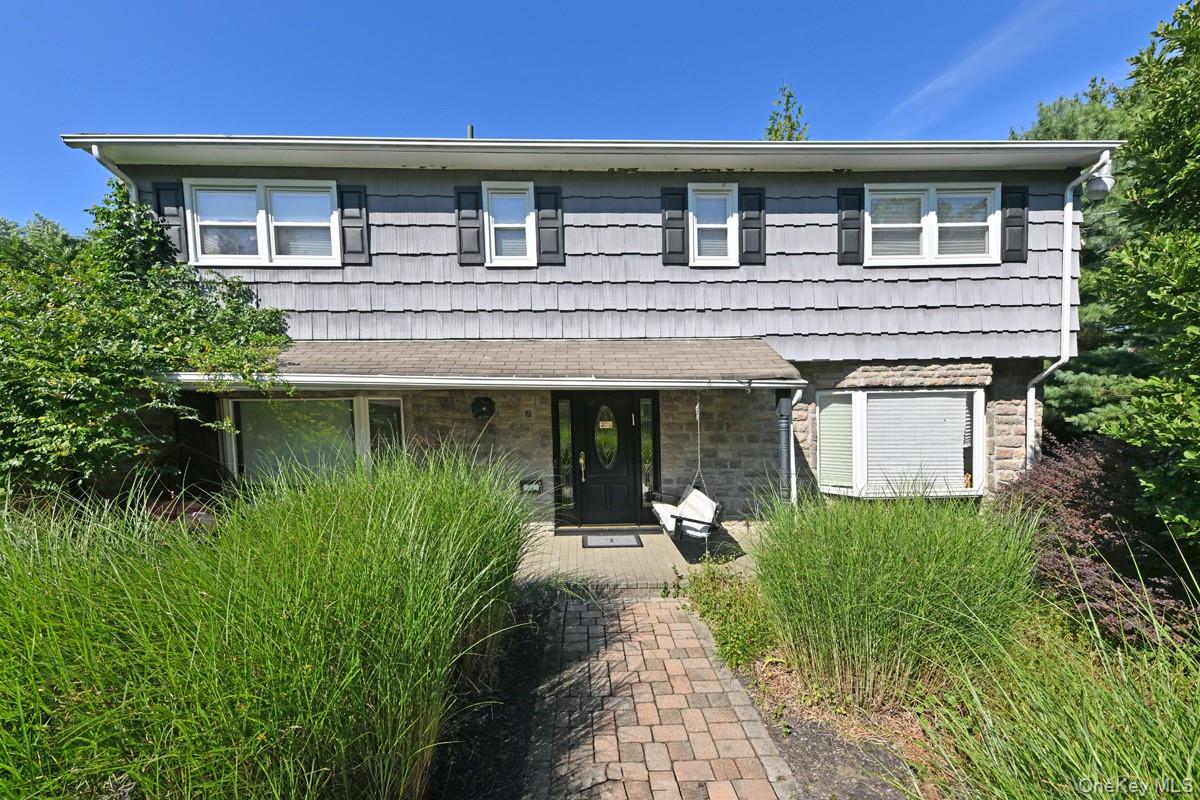 11 Deerwood Road Spring Valley, NY 10977 - Photo 15 of 34 a front view of a house with a garden and plants