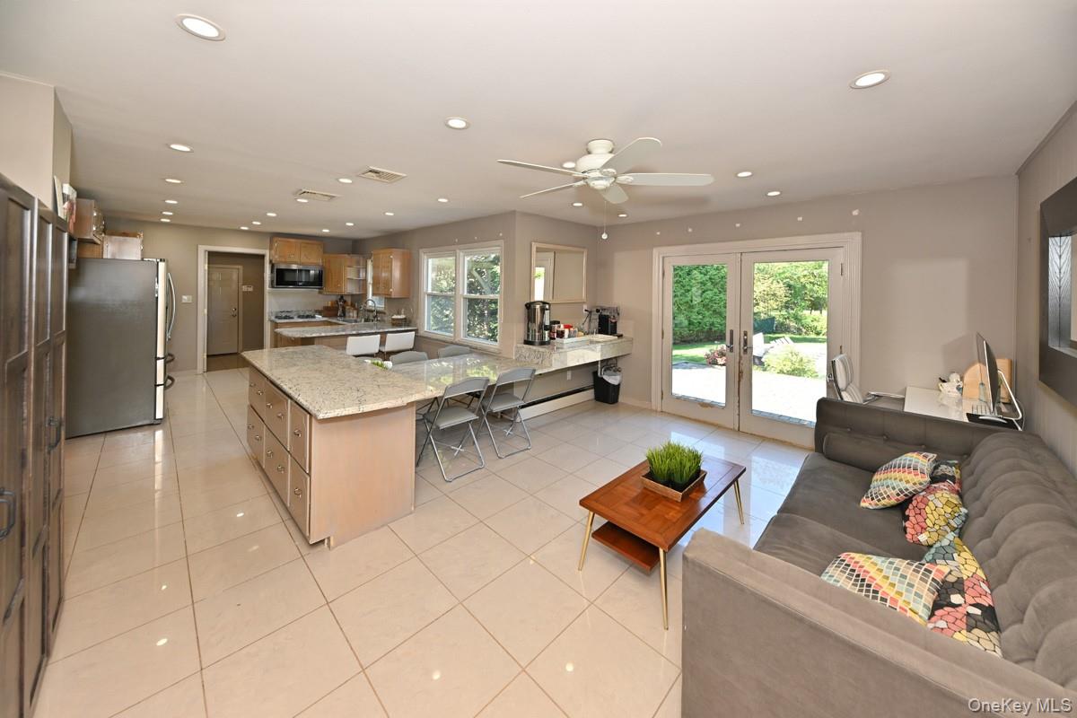 11 Deerwood Road Spring Valley, NY 10977 - Photo 17 of 34 a living room with stainless steel appliances furniture a rug and a view of kitchen