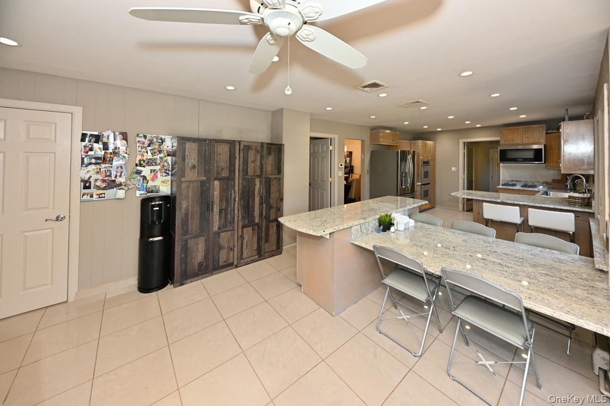 11 Deerwood Road Spring Valley, NY 10977 - Photo 19 of 34 a kitchen with stainless steel appliances kitchen island granite countertop a refrigerator and a sink