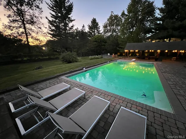 a view of a tennis ground with a large tree