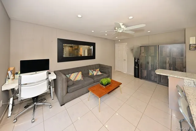 a kitchen with stainless steel appliances kitchen island granite countertop a refrigerator and a sink