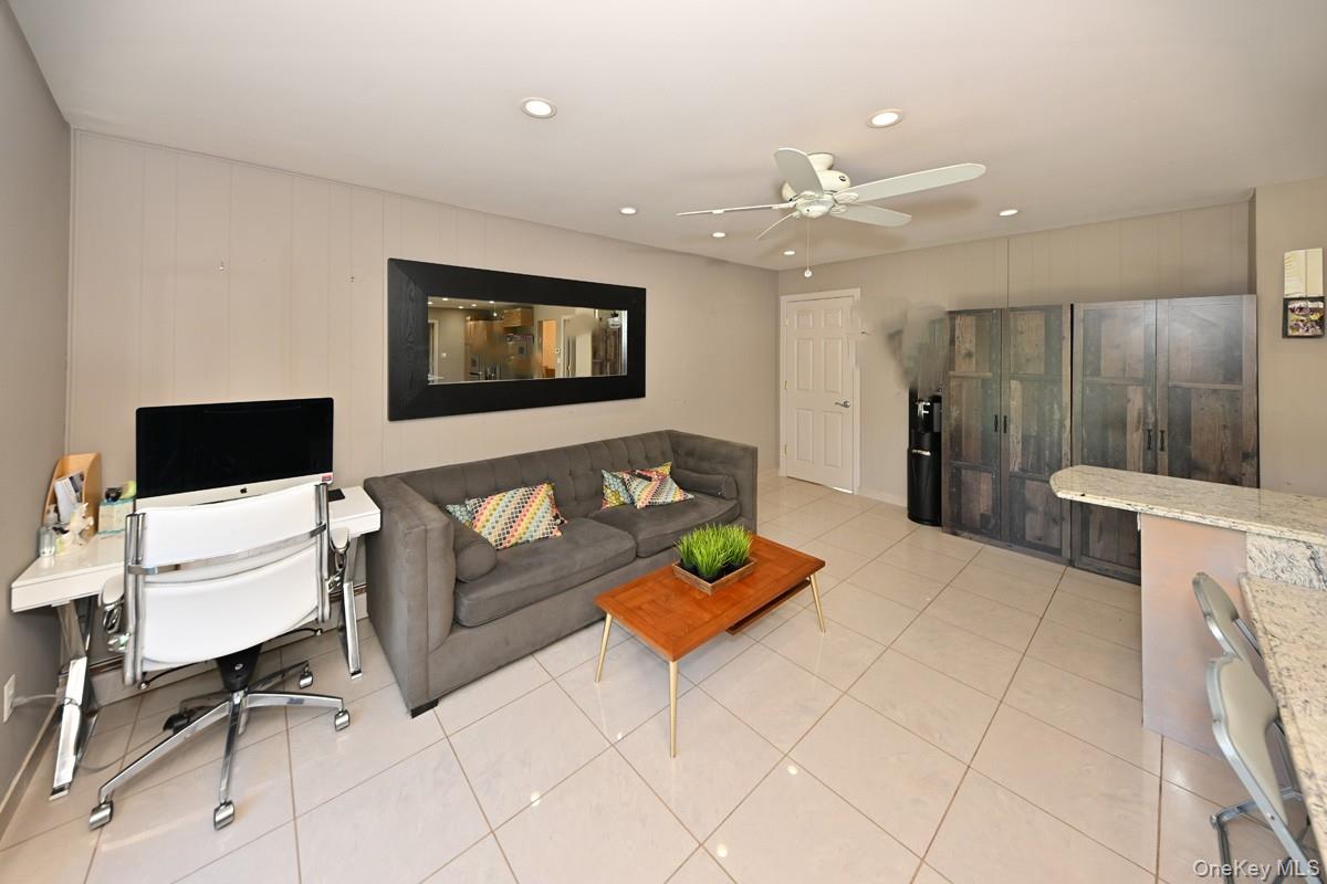 11 Deerwood Road Spring Valley, NY 10977 - Photo 20 of 34 a living room with furniture and a flat screen tv