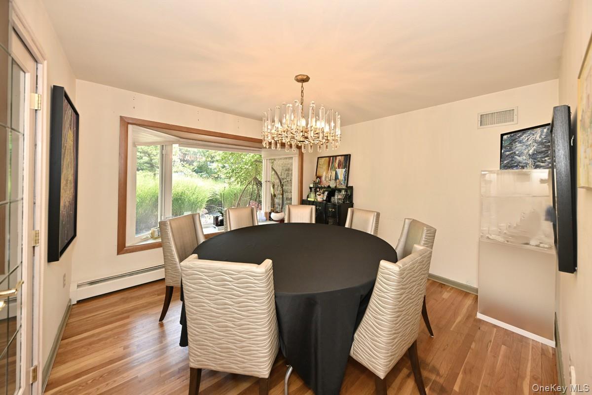 11 Deerwood Road Spring Valley, NY 10977 - Photo 24 of 34 a view of a dining room with furniture window and wooden floor