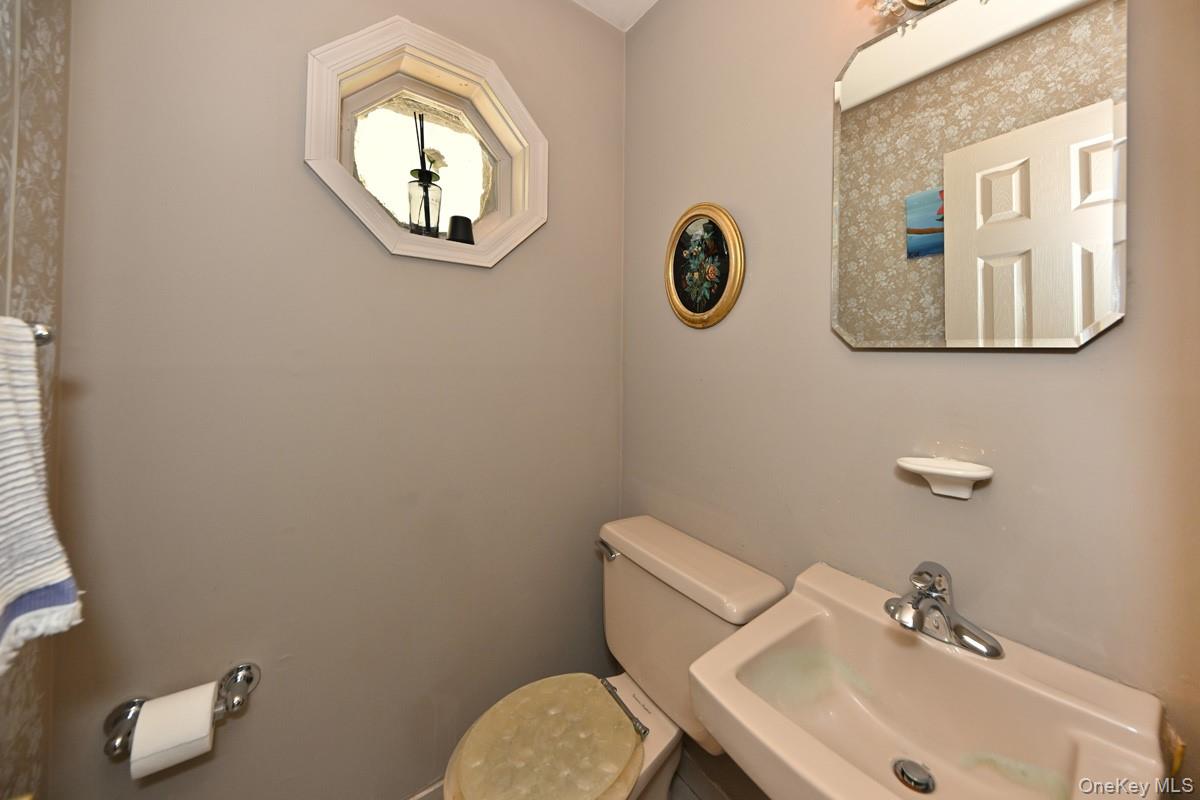 11 Deerwood Road Spring Valley, NY 10977 - Photo 25 of 34 a bathroom with a toilet sink and mirror
