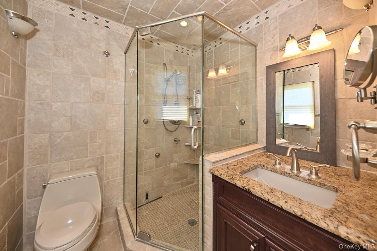 11 Deerwood Road Spring Valley, NY 10977 - Photo 28 of 34 a bathroom with a granite countertop sink toilet and shower