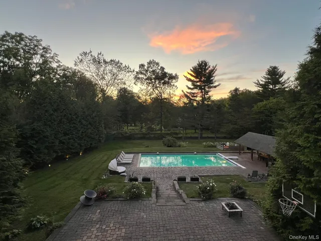 a view of a backyard with sitting area