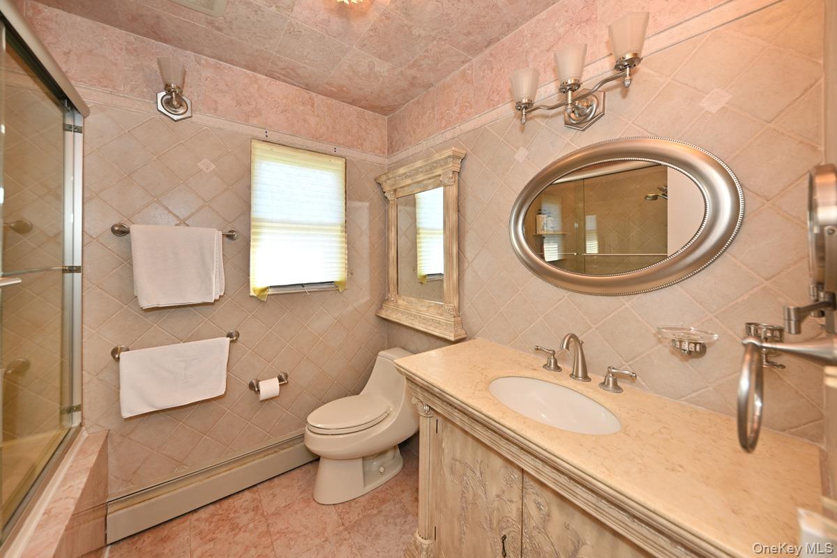 11 Deerwood Road Spring Valley, NY 10977 - Photo 30 of 34 a bathroom with a granite countertop sink and a mirror