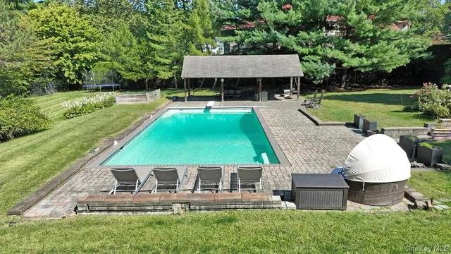 a view of a house with a yard patio and swimming pool