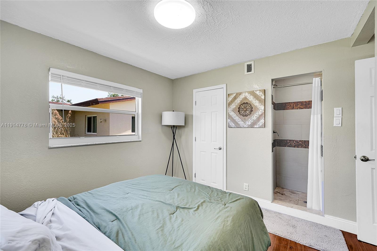 6001 Northwest 66th Terrace Tamarac, FL 33321 - Photo 16 of 30 a bedroom with a bed and a window