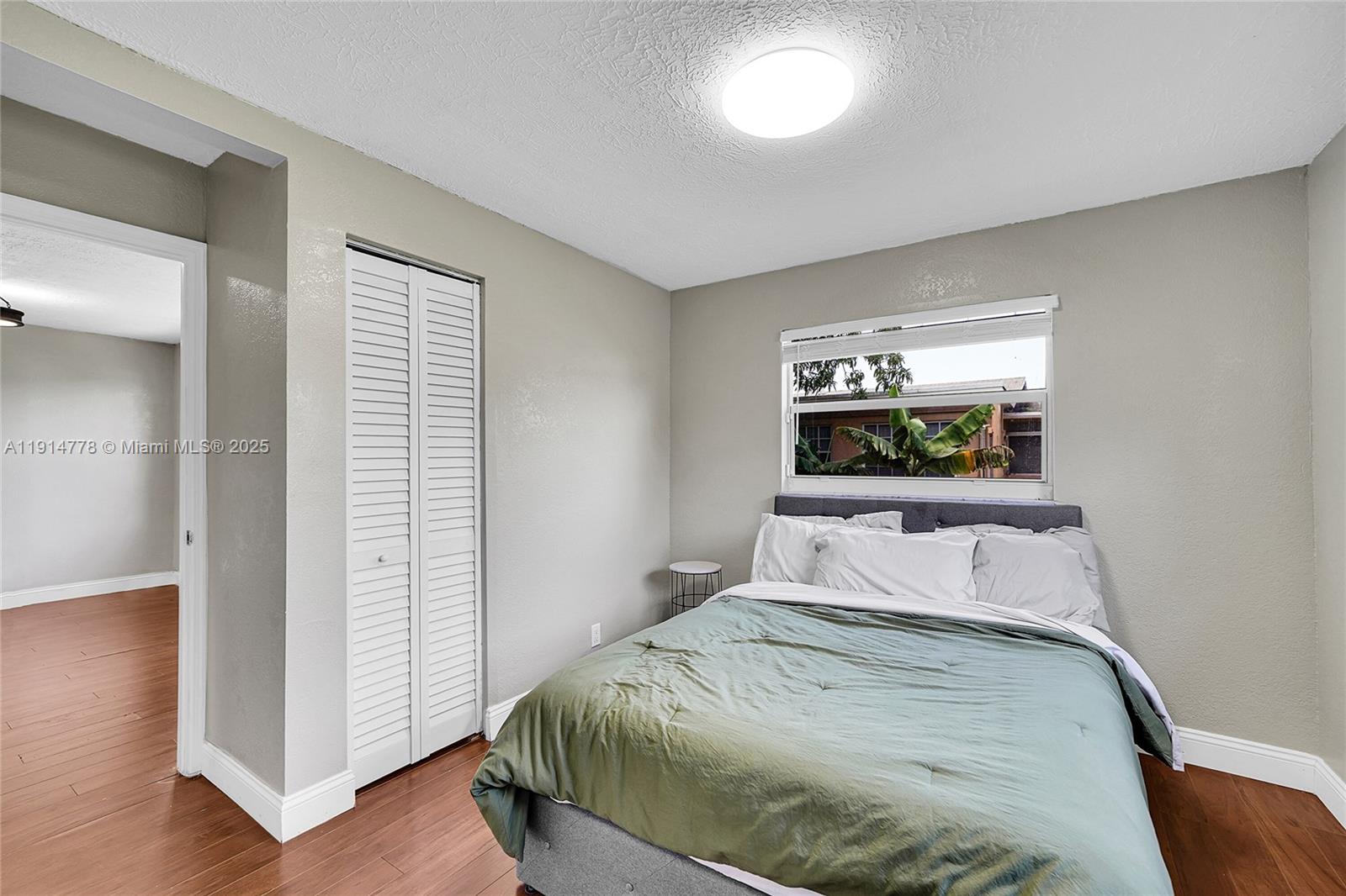 6001 Northwest 66th Terrace Tamarac, FL 33321 - Photo 17 of 30 a bedroom with a bed and a lamp