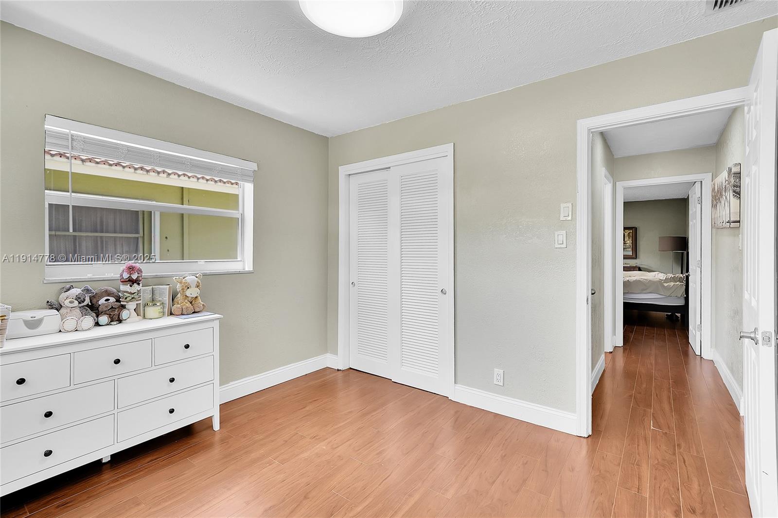 6001 Northwest 66th Terrace Tamarac, FL 33321 - Photo 20 of 30 a view of room with window and wooden floor