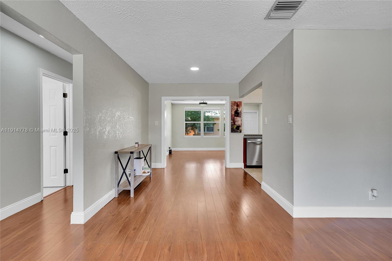 6001 Northwest 66th Terrace Tamarac, FL 33321 - Photo 6 of 30 wooden floor in an empty room with a window