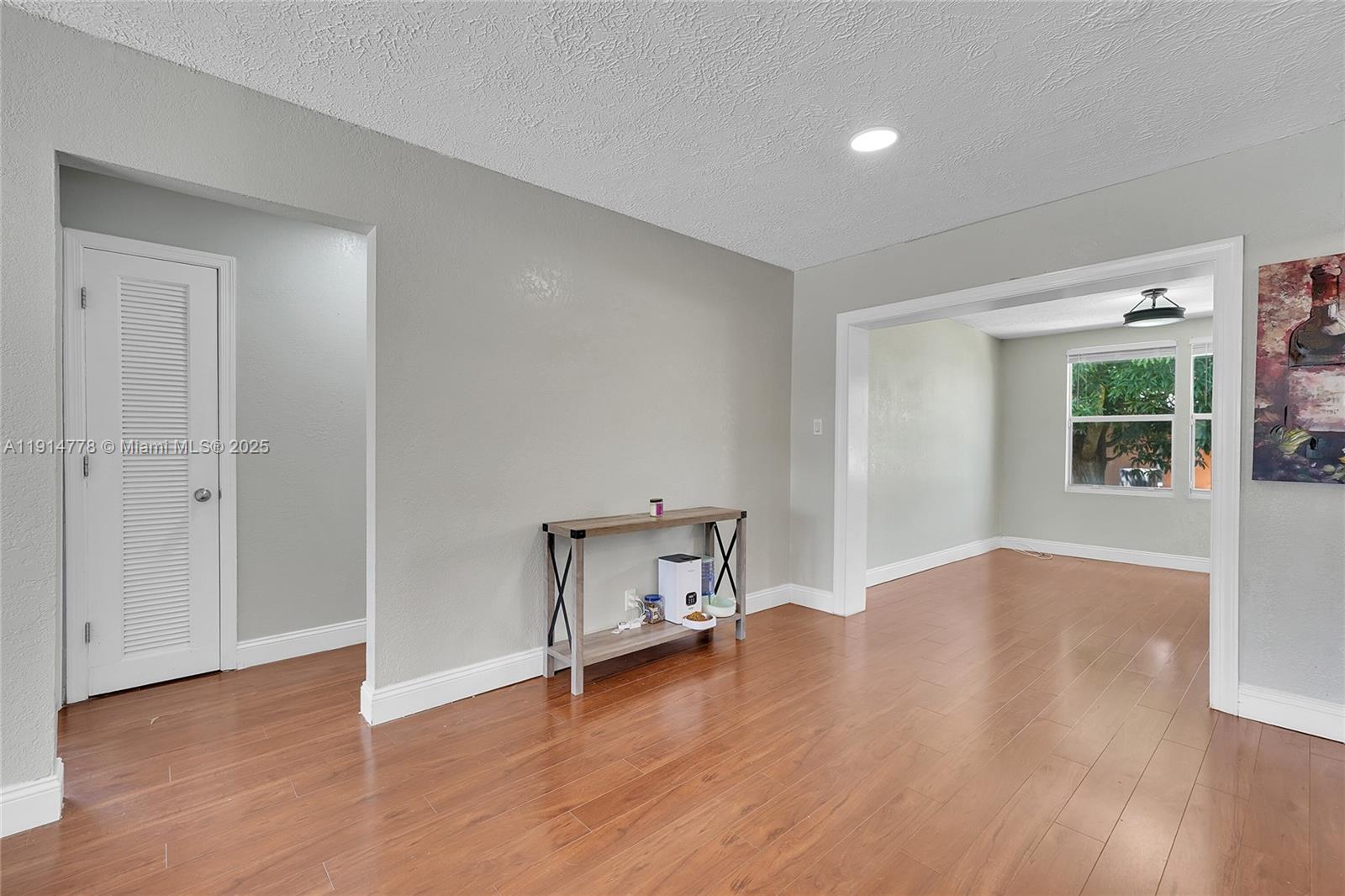 6001 Northwest 66th Terrace Tamarac, FL 33321 - Photo 7 of 30 an empty room with wooden floor and windows