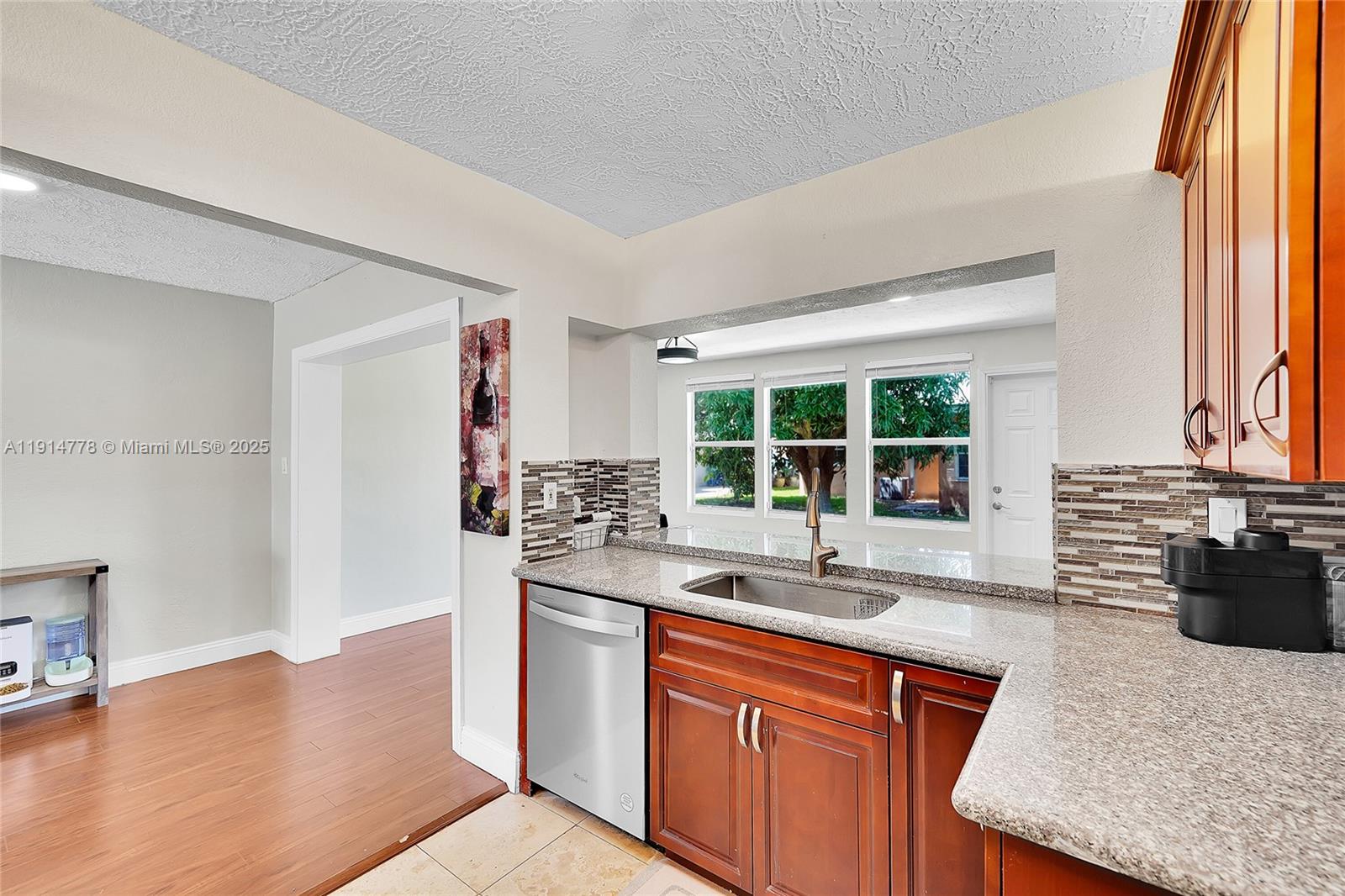 6001 Northwest 66th Terrace Tamarac, FL 33321 - Photo 10 of 30 a kitchen with stainless steel appliances granite countertop a sink stove and cabinets