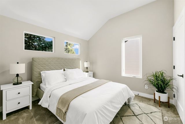 a bedroom with a bed and a potted plant