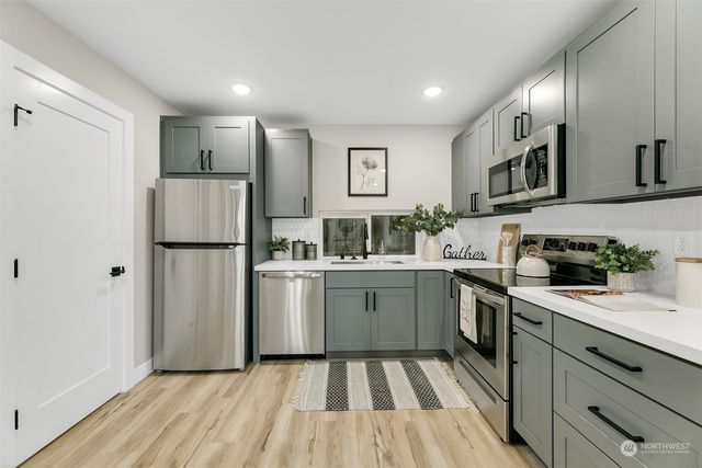 a kitchen with a sink stove and refrigerator