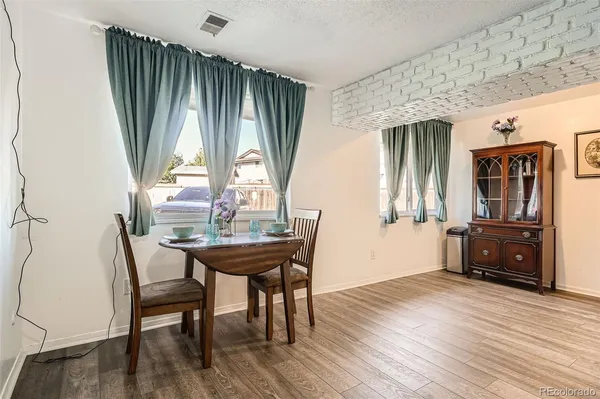 a view of a dining room with furniture and window
