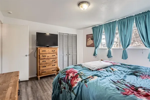 a bedroom with a bed and a television