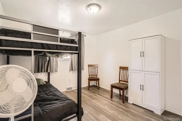 a bedroom with a bed and a chair