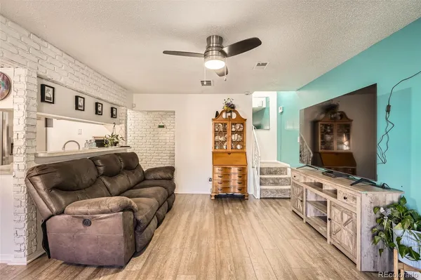 a living room with furniture and a wooden floor