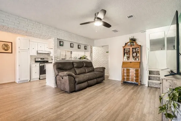a living room with furniture and wooden floor