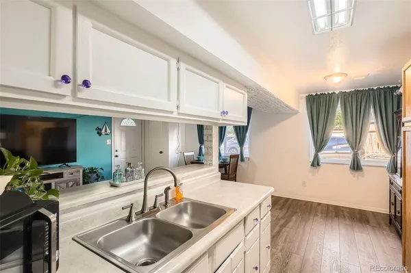 a kitchen with a sink and a refrigerator