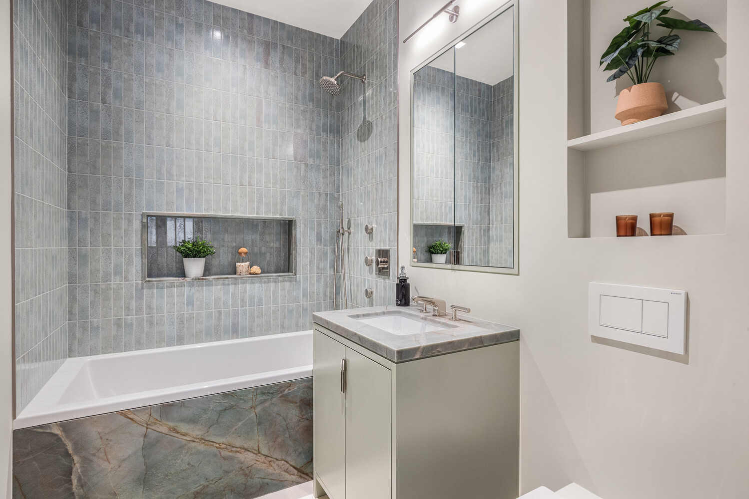 286 Spring Street, Unit 2 Manhattan, NY 10013 - Photo 10 of 14 a bathroom with a granite countertop sink a bathtub and shower