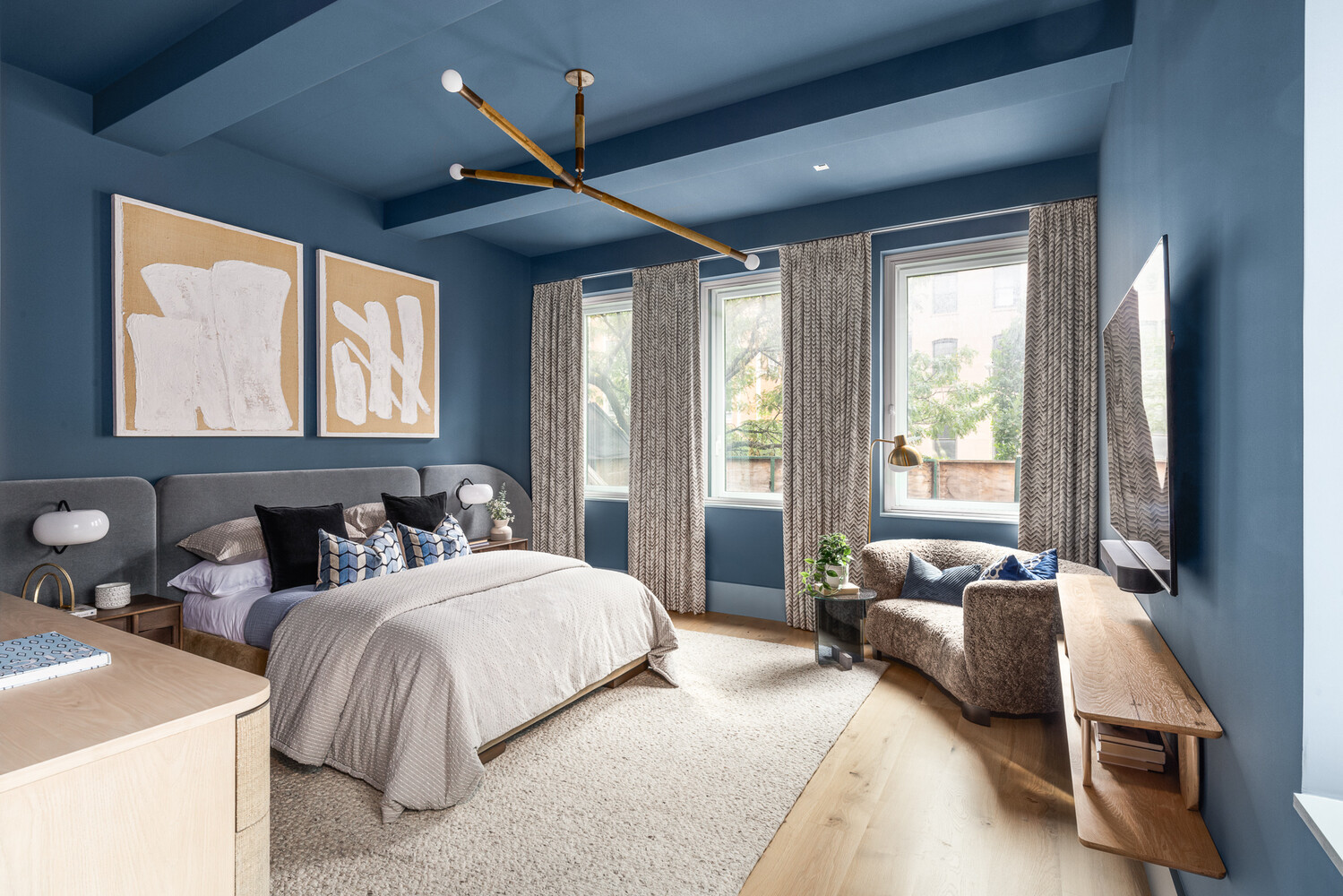 286 Spring Street, Unit 2 Manhattan, NY 10013 - Photo 5 of 14 a bedroom with a bed and a chandelier