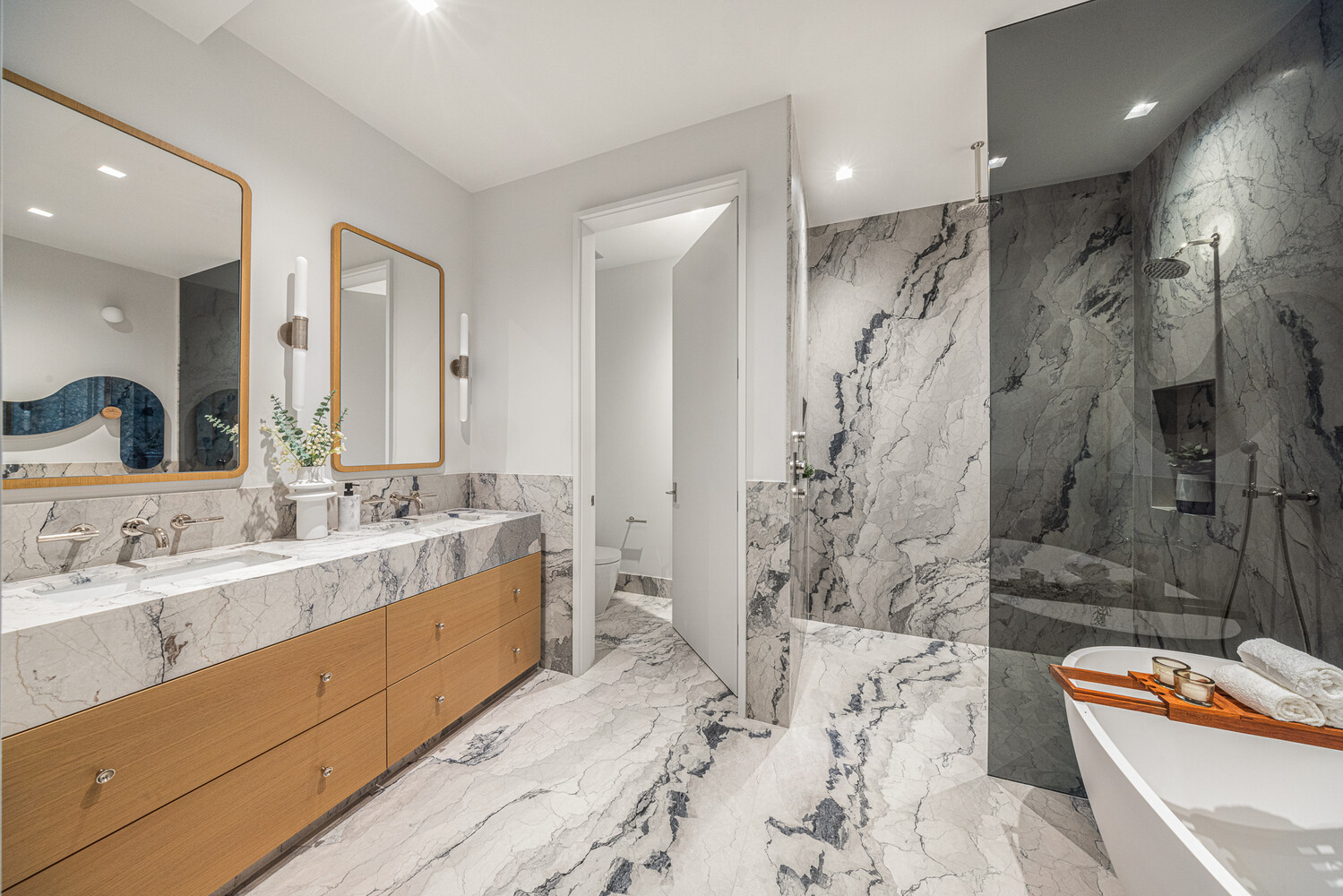 286 Spring Street, Unit 2 Manhattan, NY 10013 - Photo 8 of 14 a bathroom with a double vanity sink toilet and shower