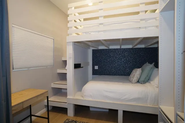 a bedroom with a bed and a potted plant