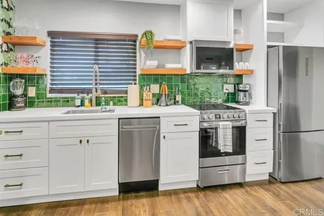 a kitchen with a refrigerator and a stove